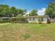 Charming single-story home with a well-maintained front lawn, complemented by lush greenery and a welcoming facade at 920 Gloriosa Ave, Winter Park, FL 32789