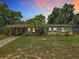 Charming single-story home with a lush front yard, mature trees, and a covered carport showcasing curb appeal at 920 Gloriosa Ave, Winter Park, FL 32789