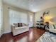 Bright living room featuring hardwood floors, comfortable seating, a front door, and lots of natural light at 920 Gloriosa Ave, Winter Park, FL 32789