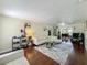 Spacious living room with hardwood floors, comfortable seating, and an open floor plan, leading to the dining area at 920 Gloriosa Ave, Winter Park, FL 32789