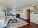 Spacious living room featuring modern decor, wood floors, and ample natural light from the adjacent dining room at 920 Gloriosa Ave, Winter Park, FL 32789