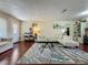 The open living space showcases hardwood floors, modern furniture, and an open entryway to the dining area at 920 Gloriosa Ave, Winter Park, FL 32789