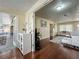Open-concept living room with wood floors, white cabinet and view to the sun room at 920 Gloriosa Ave, Winter Park, FL 32789
