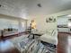 Open-concept living room featuring hardwood floors, white couches, and easy access to the kitchen area at 920 Gloriosa Ave, Winter Park, FL 32789
