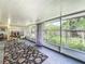 Bright sunroom with large windows offering serene views of the well-maintained backyard at 920 Gloriosa Ave, Winter Park, FL 32789