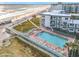 Aerial view showcasing a beachfront condominium community with an outdoor swimming pool and beach access at 935 S Atlantic Ave # 355, Daytona Beach, FL 32118