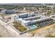 Wide aerial view of condominium complex with pool, beach access, and Intracoastal views at 935 S Atlantic Ave # 355, Daytona Beach, FL 32118