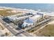 Aerial view of Ocean Jewels Club resort with lush palm trees, parking, and the beach in Daytona Beach Shores, FL at 935 S Atlantic Ave # 355, Daytona Beach, FL 32118