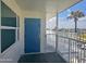 Exterior view of the apartment's entry, with a door, a balcony, and partial views at 935 S Atlantic Ave # 355, Daytona Beach, FL 32118