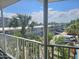 Balcony view showcasing lush palm trees, tropical landscaping, and buildings at 935 S Atlantic Ave # 355, Daytona Beach, FL 32118