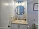 This bathroom features a vanity with a large round mirror and stylish fixtures at 935 S Atlantic Ave # 355, Daytona Beach, FL 32118