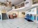 Bright lobby featuring beach-themed mural, tile floors, staircase, and comfortable seating area at 935 S Atlantic Ave # 355, Daytona Beach, FL 32118