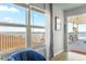Bright condo view of the Daytona Beach Shores oceanfront with comfortable blue chair and sunny porch at 935 S Atlantic Ave # 355, Daytona Beach, FL 32118