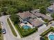 Home featuring a private pool, manicured landscaping, and a paver patio, ideal for outdoor living at 10100 Loblolly Pine Cir, Orlando, FL 32827