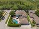 Expansive home showcasing a backyard oasis with a sparkling pool, lush greenery, and ample parking at 10100 Loblolly Pine Cir, Orlando, FL 32827