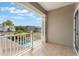 Tiled balcony with white railings overlooking a sparkling pool and lush landscaping at 10100 Loblolly Pine Cir, Orlando, FL 32827