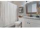 Updated bathroom featuring decorative shelf, granite counter, framed mirror and shower at 10100 Loblolly Pine Cir, Orlando, FL 32827