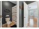 Bathroom with dark gray walls and an open doorway to a bedroom at 10100 Loblolly Pine Cir, Orlando, FL 32827