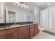 Bathroom with a large vanity with a sink and a shower behind a curtain at 10100 Loblolly Pine Cir, Orlando, FL 32827