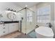 Bright and spacious bathroom with dual vanity, soaking tub and glass shower at 10100 Loblolly Pine Cir, Orlando, FL 32827