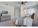 Bedroom with a ceiling fan, gray carpet, and a dresser with television at 10100 Loblolly Pine Cir, Orlando, FL 32827