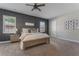 Bedroom with a ceiling fan, gray carpet, and a dark accent wall at 10100 Loblolly Pine Cir, Orlando, FL 32827