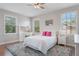 Bright bedroom with hardwood floors, a ceiling fan, and an illuminated vanity at 10100 Loblolly Pine Cir, Orlando, FL 32827