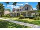 Charming two-story home featuring a spacious front porch, manicured lawn, and beautiful landscaping at 10100 Loblolly Pine Cir, Orlando, FL 32827