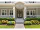 Inviting front entrance with double doors, manicured bushes, and a well-maintained walkway at 10100 Loblolly Pine Cir, Orlando, FL 32827