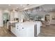 Bright kitchen boasts a large island with white cabinets, stainless steel appliances, and an open view to the living area at 10100 Loblolly Pine Cir, Orlando, FL 32827