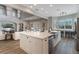 Open kitchen with a large island, stainless appliances, and built-in desk area, connecting to living spaces at 10100 Loblolly Pine Cir, Orlando, FL 32827