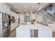 Modern kitchen featuring white cabinets, stainless steel appliances, a spacious island, and an open layout design at 10100 Loblolly Pine Cir, Orlando, FL 32827