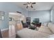Comfortable living room with a ceiling fan and an open layout to the upstairs hallway at 10100 Loblolly Pine Cir, Orlando, FL 32827