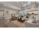 Open concept living room with a large rug, neutral furniture, and open access to the kitchen and patio doors at 10100 Loblolly Pine Cir, Orlando, FL 32827