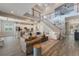 Open concept living room features a staircase, second floor balcony and kitchen with white cabinets at 10100 Loblolly Pine Cir, Orlando, FL 32827