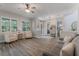 Bright living room with wood flooring, comfortable seating, and natural light from large windows at 10100 Loblolly Pine Cir, Orlando, FL 32827