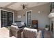 Covered outdoor patio featuring a fireplace, ceiling fan, and comfortable seating at 10100 Loblolly Pine Cir, Orlando, FL 32827