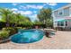 Beautiful pool area with lush landscaping, a playful basketball hoop, and outdoor seating at 10100 Loblolly Pine Cir, Orlando, FL 32827