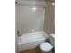 Bathroom with a tiled shower-tub combo, white fixtures, and neutral tile at 1051 S Hiawassee Rd # 2136, Orlando, FL 32835