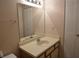 Cozy bathroom featuring an updated sink and vanity, mirror, and ample storage at 1051 S Hiawassee Rd # 2136, Orlando, FL 32835