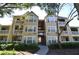 Beautiful condo building featuring balconies, mature landscaping, and a courtyard entrance at 1051 S Hiawassee Rd # 2136, Orlando, FL 32835