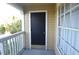 Exterior front door is located on a small covered porch with a window and railings at 1051 S Hiawassee Rd # 2136, Orlando, FL 32835