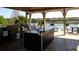 Outdoor grilling area features multiple grills, countertop space, and scenic views of the lake at 1051 S Hiawassee Rd # 2136, Orlando, FL 32835