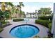 Community hot tub and seating area surrounded by lush, tropical landscaping at 1051 S Hiawassee Rd # 2136, Orlando, FL 32835