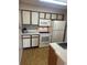Functional kitchen featuring white appliances, tiled backsplash, and ample cabinet space at 1051 S Hiawassee Rd # 2136, Orlando, FL 32835