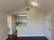 Open living room view into the kitchen, featuring neutral walls and hardwood floors at 1051 S Hiawassee Rd # 2136, Orlando, FL 32835