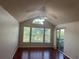 Bright living room with vaulted ceilings, large windows, ceiling fan, and access to a balcony at 1051 S Hiawassee Rd # 2136, Orlando, FL 32835