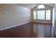 Bright living room featuring a vaulted ceiling, large windows, and hardwood floors at 1051 S Hiawassee Rd # 2136, Orlando, FL 32835