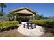 Outdoor picnic area with a gazebo, picnic table, grill, and lush landscaping near the water at 1051 S Hiawassee Rd # 2136, Orlando, FL 32835