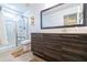 Modern bathroom featuring a glass shower, a large framed mirror, and under-sink vanity storage at 109 Kenny Blvd, Haines City, FL 33844